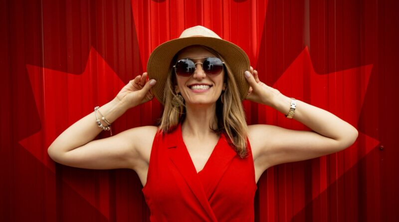 Woman in Red Sleeveless Dress With Canada Flag Printed Background