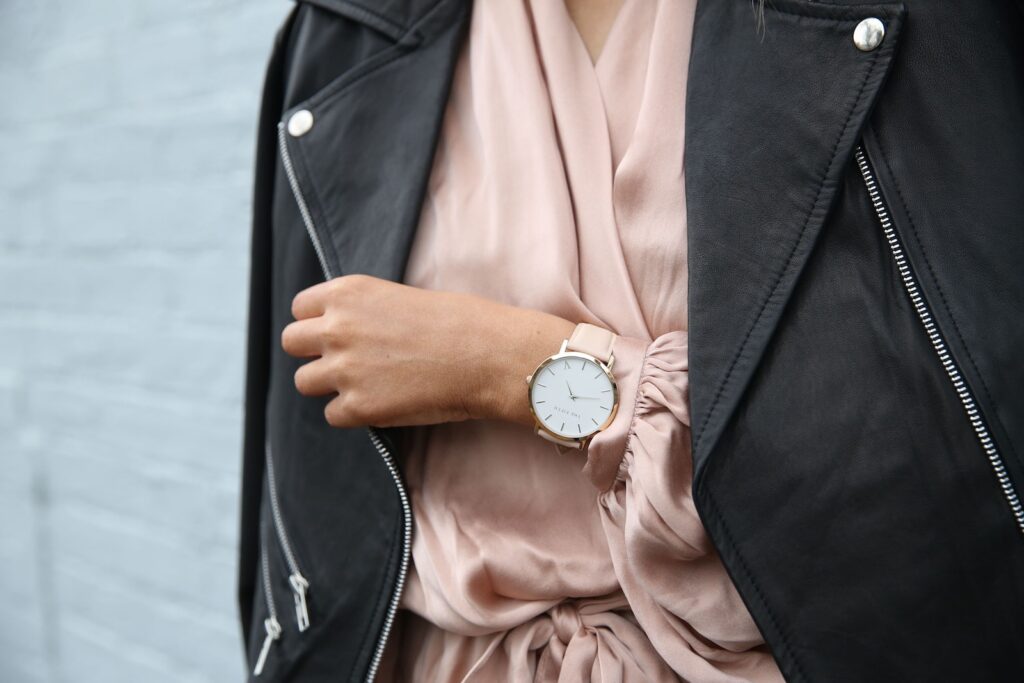 Woman Wearing Peach Dress and Black Jacket's Left Hand Closeup Photography