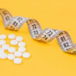 white round medication pill on yellow surface